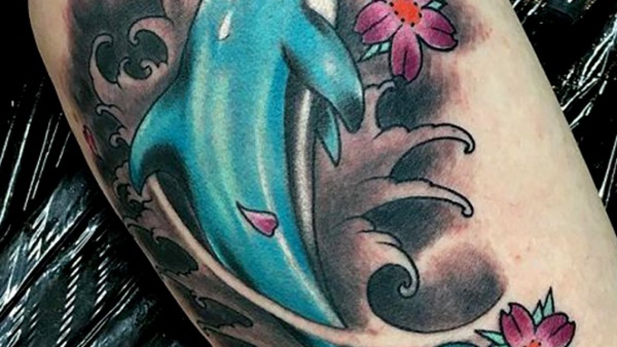 Tattoo uploaded by Veera  dolphintattoo dolphin flowertattoo flower  flowers   Tattoodo